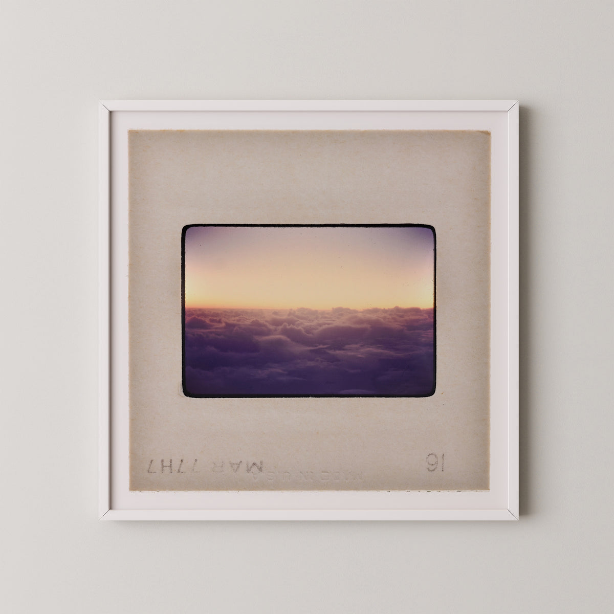 The image is a framed photograph of a sunset over a cloudy sky.