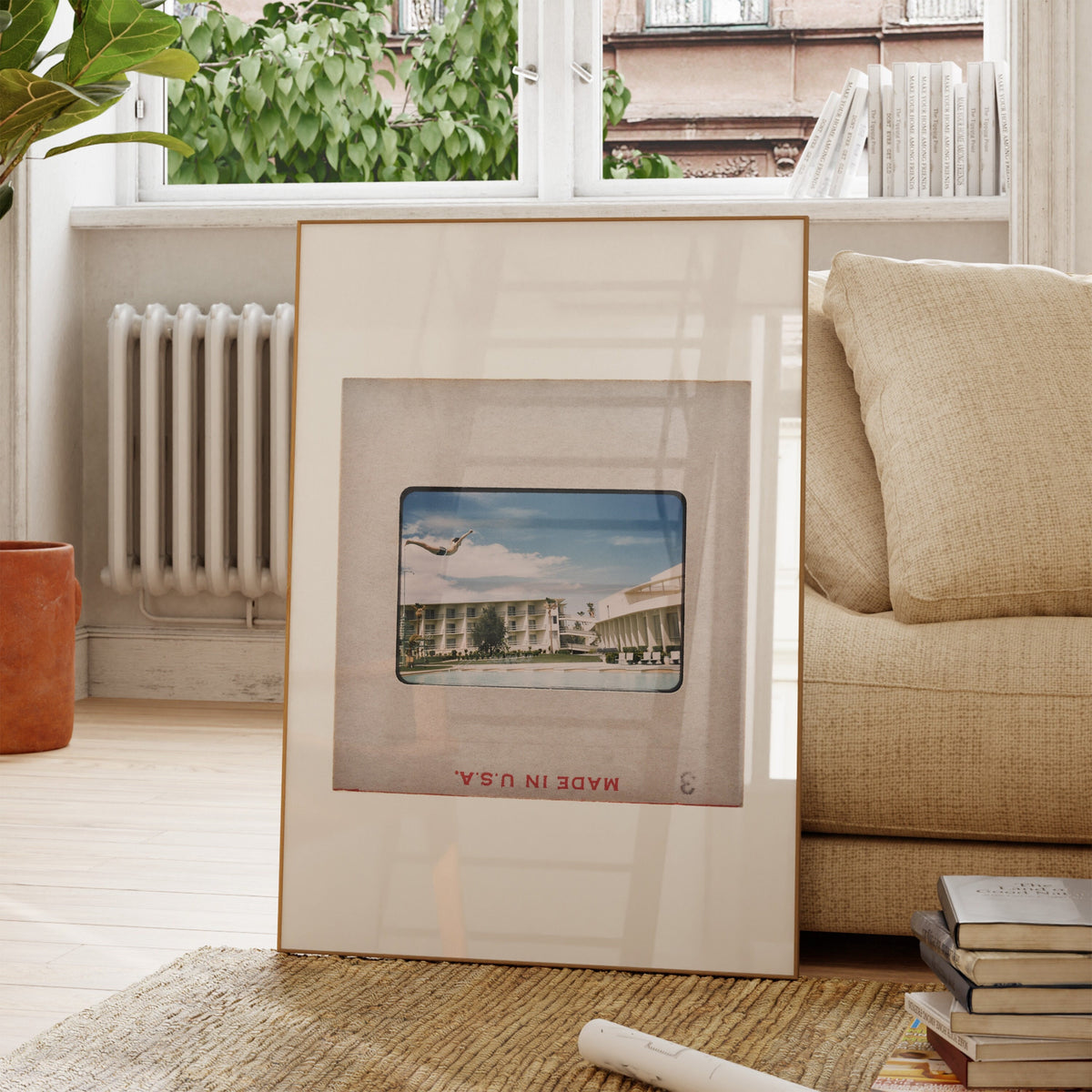 a framed photograph of a building, placed on a rug in a living room setting.