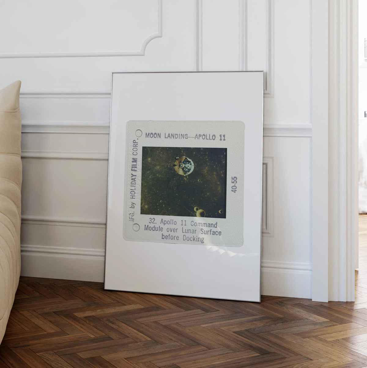 a framed photograph of the Apollo 11 moon landing, with the text "Moon Landing - Apollo 11" and "Apollo 11" visible.