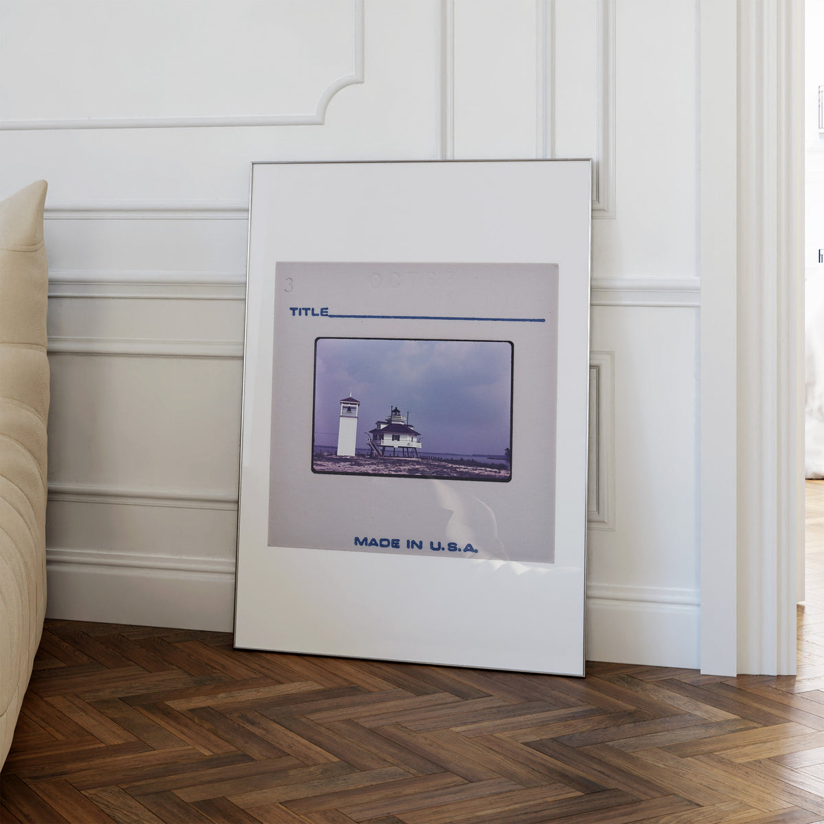 a framed photograph of a lighthouse on a wooden floor, with the text "MADE IN U.S.A." below the image.