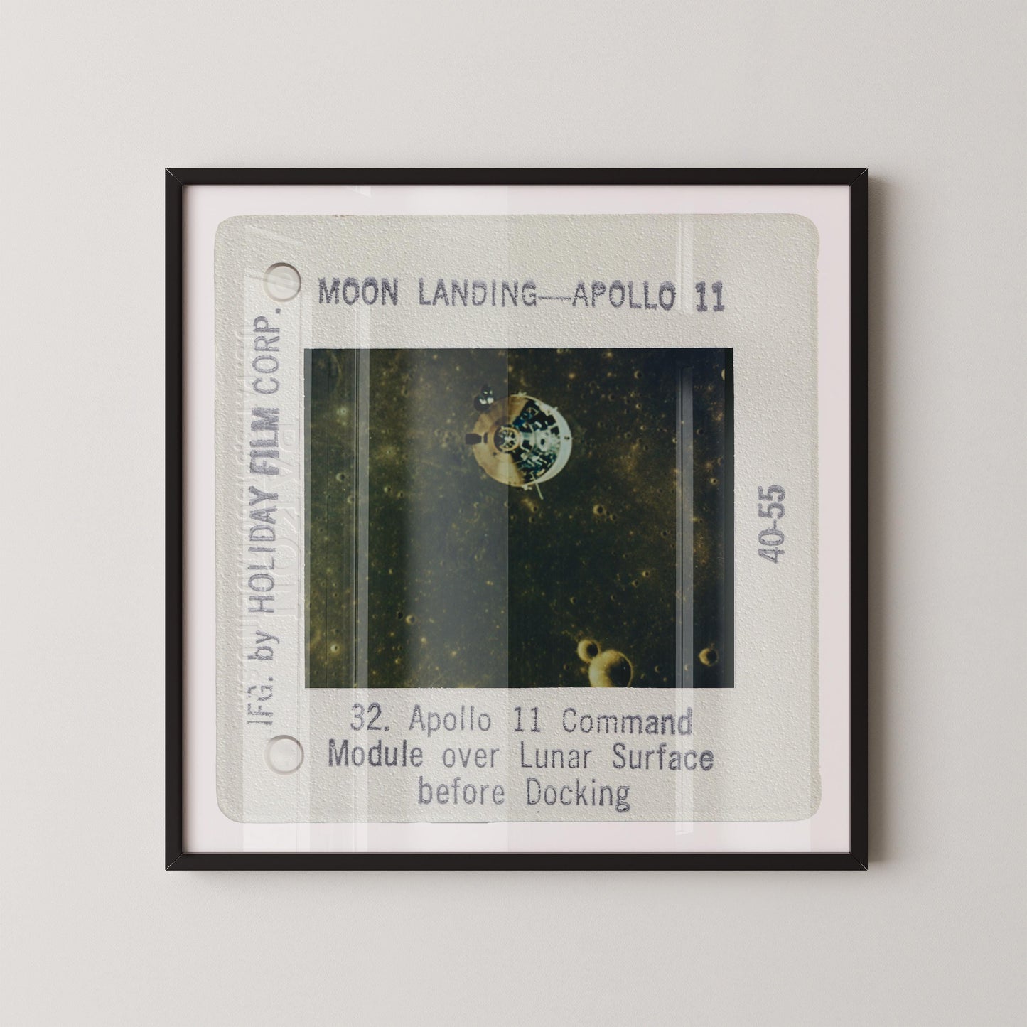 The image is a framed photograph of a space shuttle, specifically Apollo 11, during its moon landing.