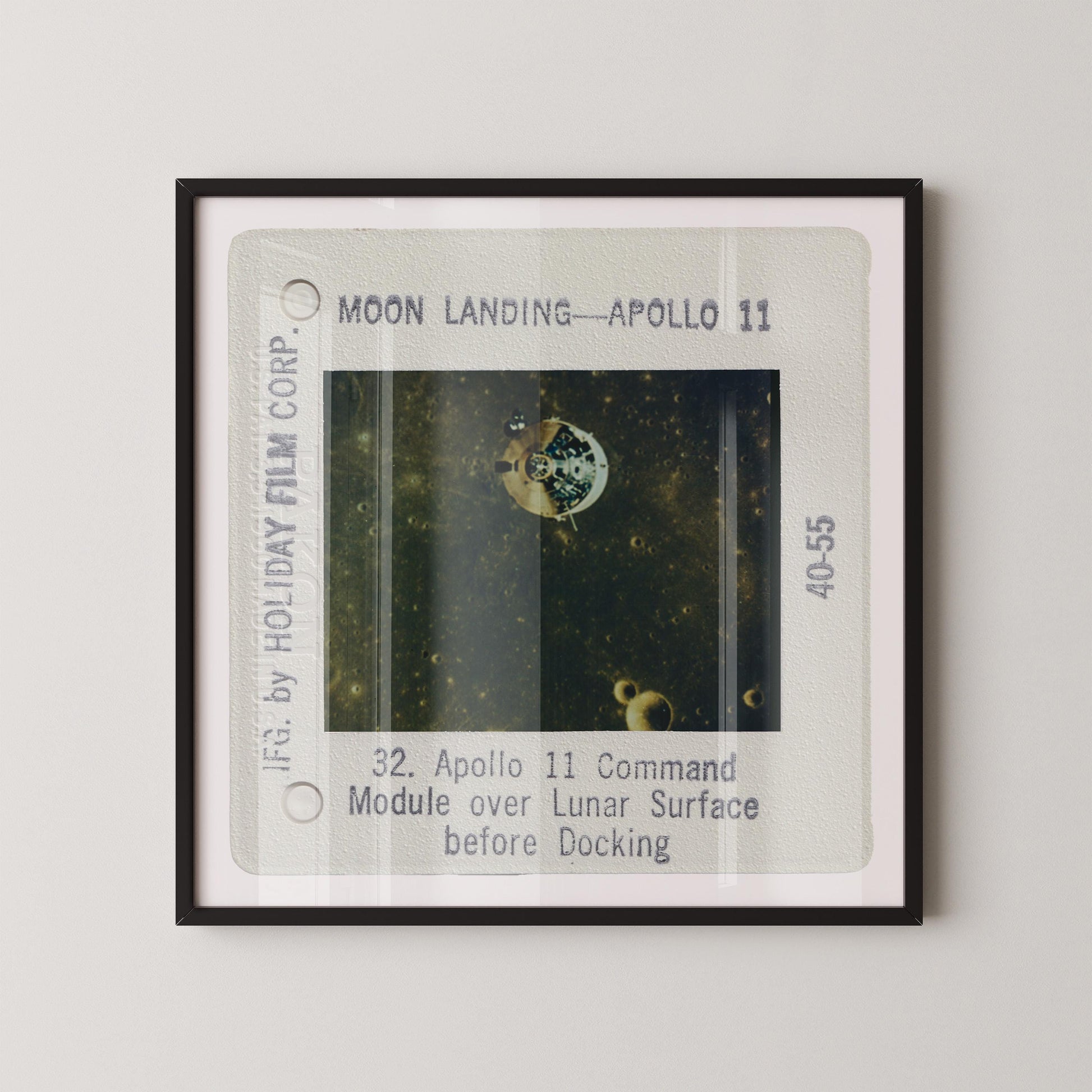 The image is a framed photograph of a space shuttle, specifically Apollo 11, during its moon landing.