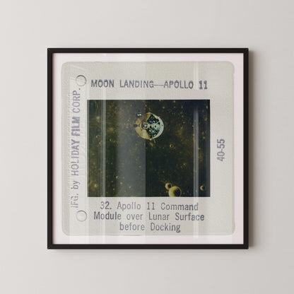 The image is a framed photograph of a space shuttle, specifically Apollo 11, during its moon landing.