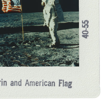 an astronaut walking on the surface of the moon, with an American flag visible in the background.