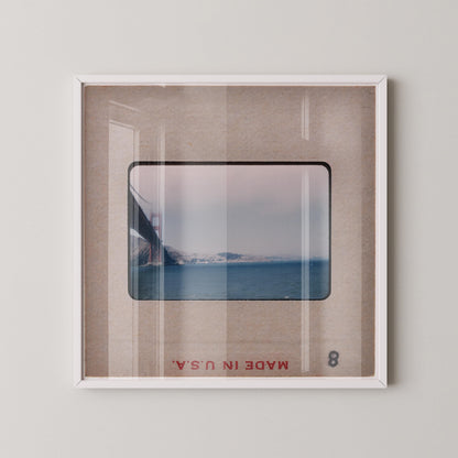 The image is a framed photograph of the Golden Gate Bridge, a famous landmark in San Francisco, California.