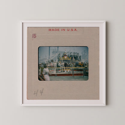 The image is a framed photograph of a carnival ride, with the text "MADE IN U.S.A." printed on the frame.