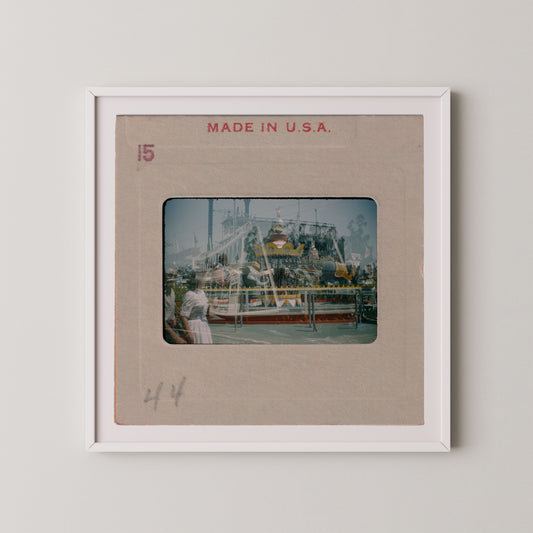The image is a framed photograph of a carnival ride, with the text "MADE IN U.S.A." printed on the frame.