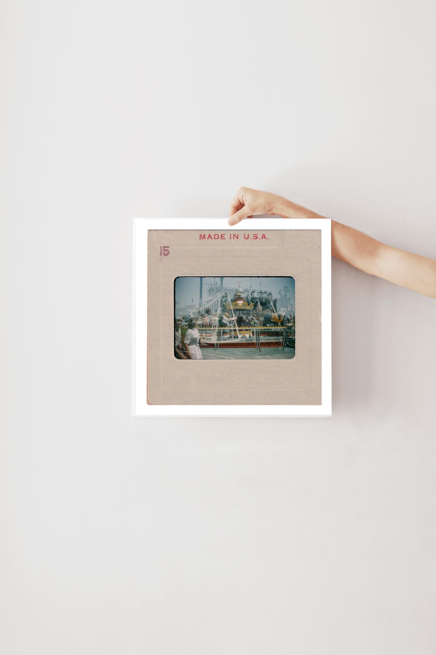 A person's hand is holding a framed photograph of a ship or boat, with the text "MADE IN U.S.A." printed on the frame.