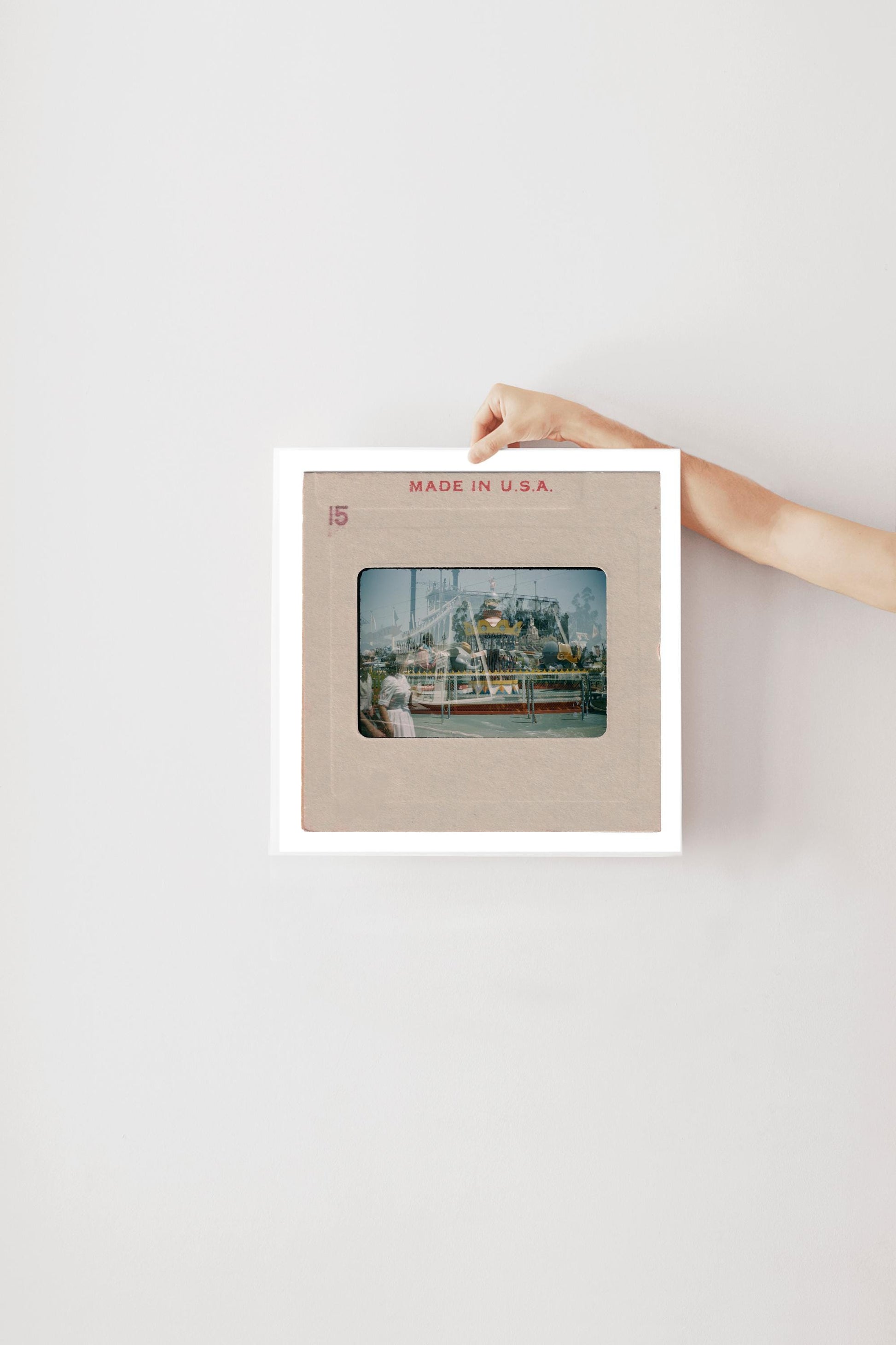 A person's hand is holding a framed photograph of a ship or boat, with the text "MADE IN U.S.A." printed on the frame.
