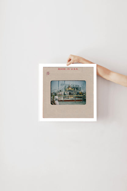 A person's hand is holding a framed photograph of a ship or boat, with the text "MADE IN U.S.A." printed on the frame.