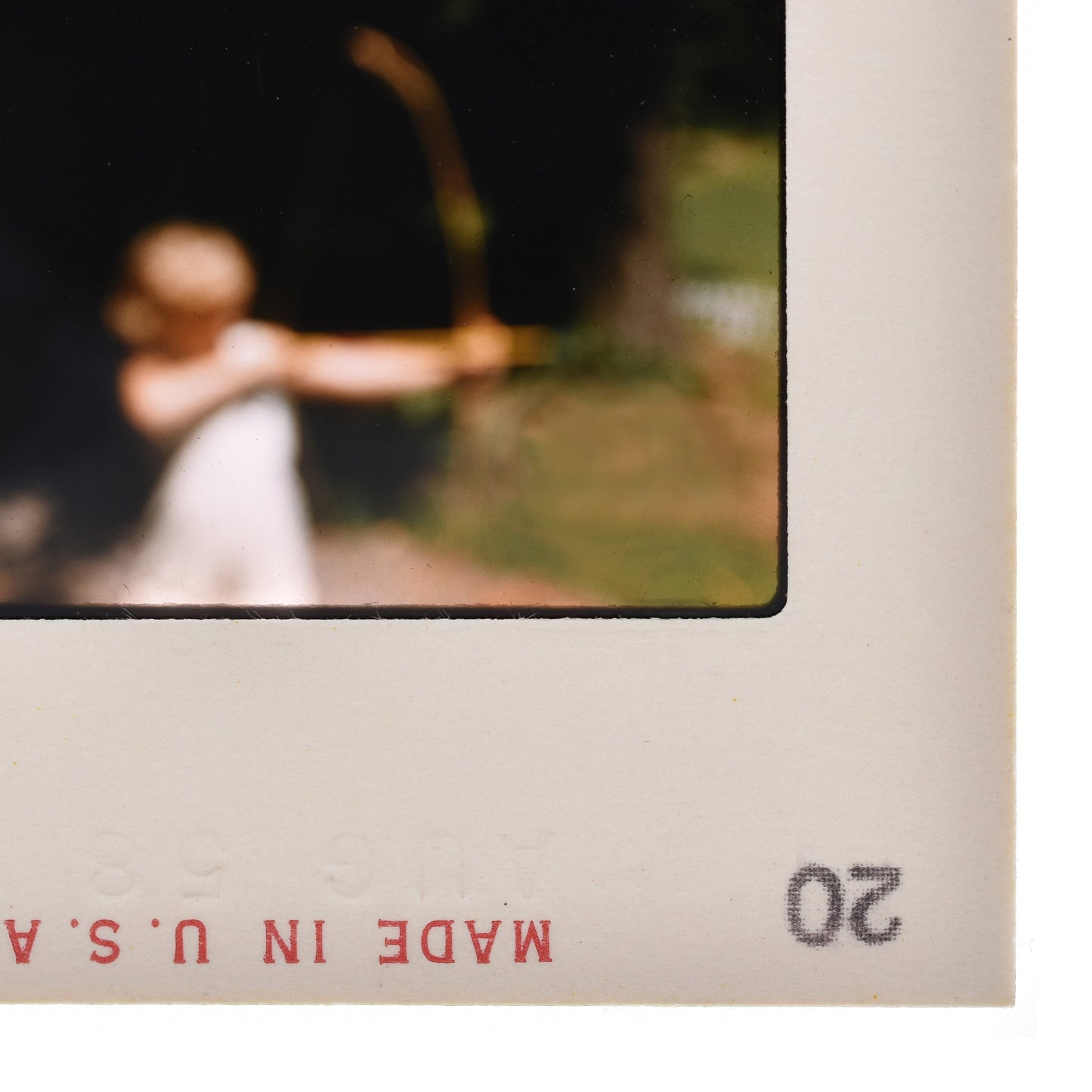 a person holding a bow and arrow, with a blurred background.