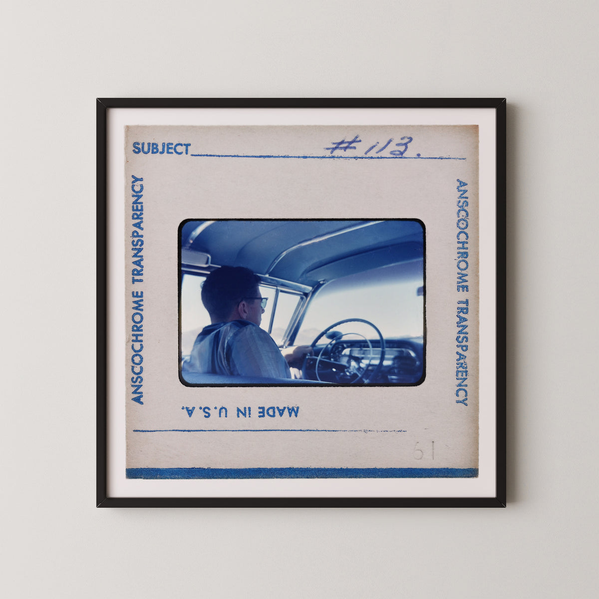 The image is a framed photograph of a person sitting in a car, with the frame labeled "Subject" and "#123".