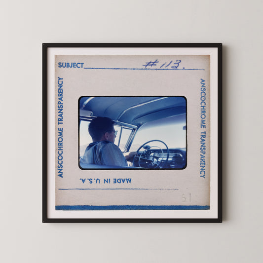 The image is a framed photograph of a person sitting in a car, with the frame labeled "Subject" and "#123".