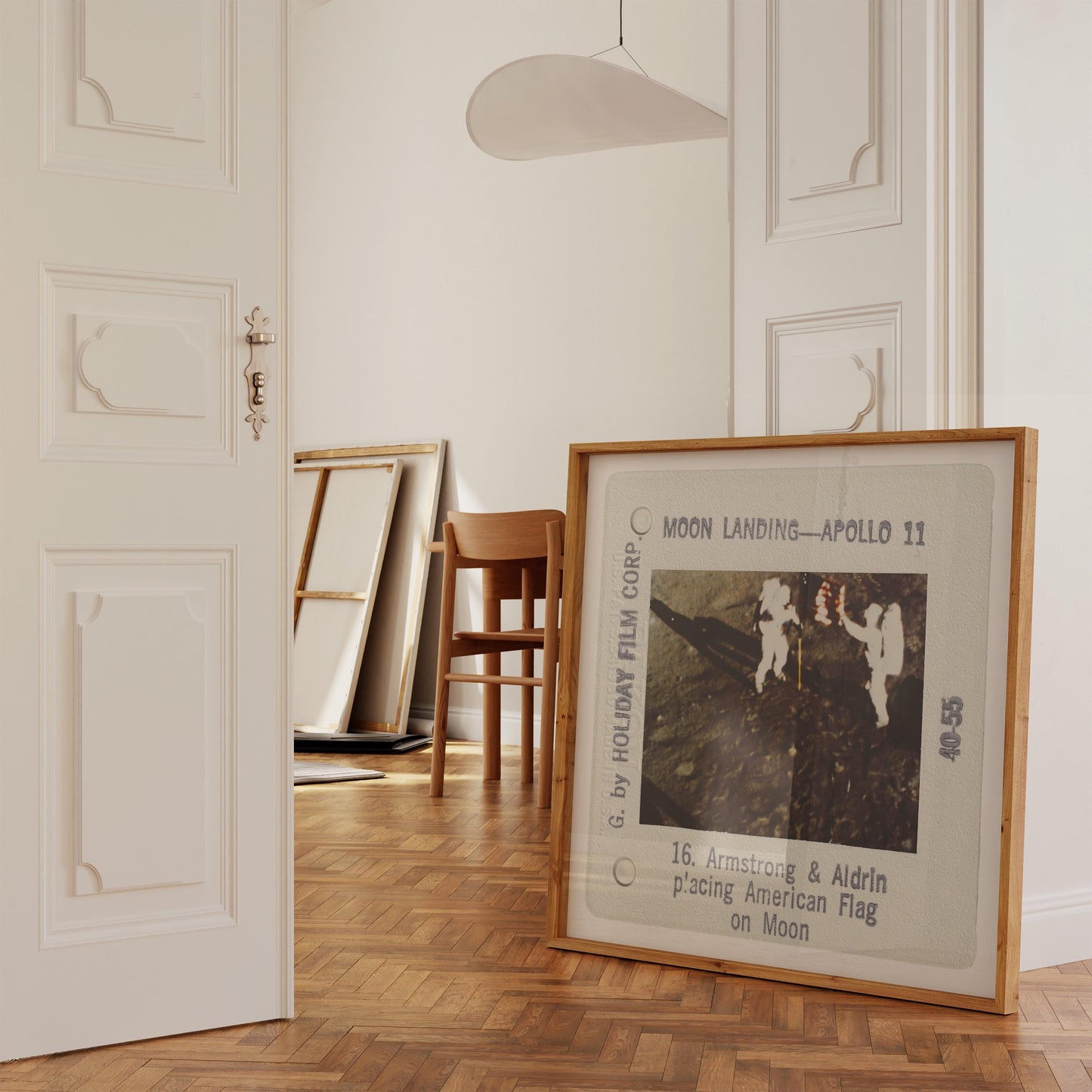 a framed photograph of the Apollo 11 moon landing, with the text "Moon Landing - Apollo 11" and "16. Armstrong & Aldrin placing American Flag on Moon" visible.
