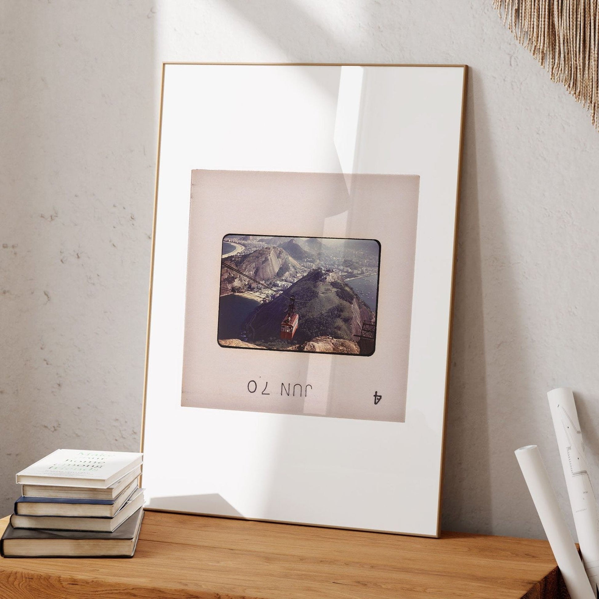a framed photograph of a mountain landscape, with a small text overlay that reads "JUN".