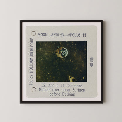 The image is a framed photograph of the Apollo 11 moon landing, showing the lunar module over the lunar surface before docking.
