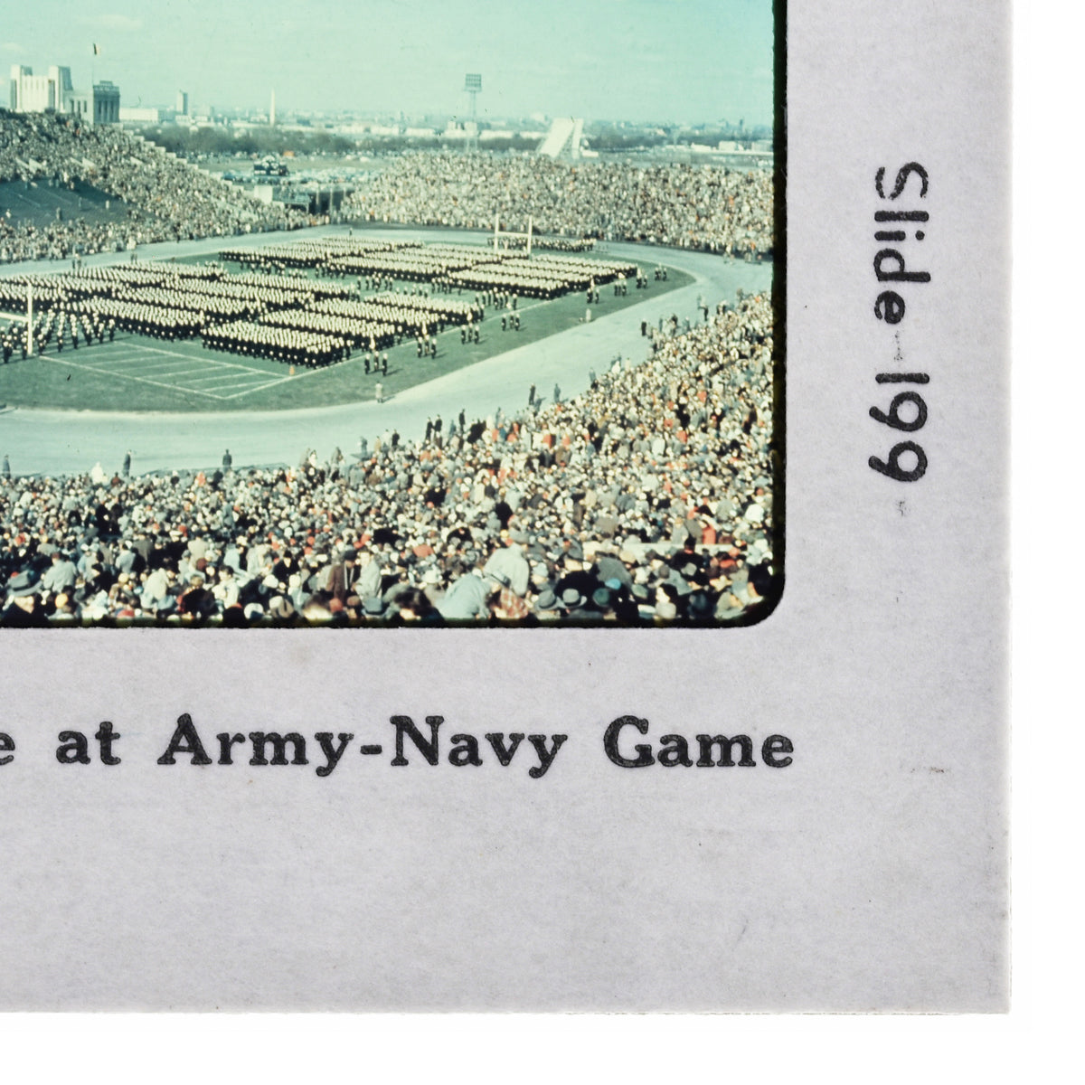 a large crowd of people gathered in a stadium, with rows of people standing in the stands.