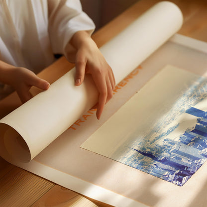 A person's hands are holding a roll of paper over a printed image of a cityscape.