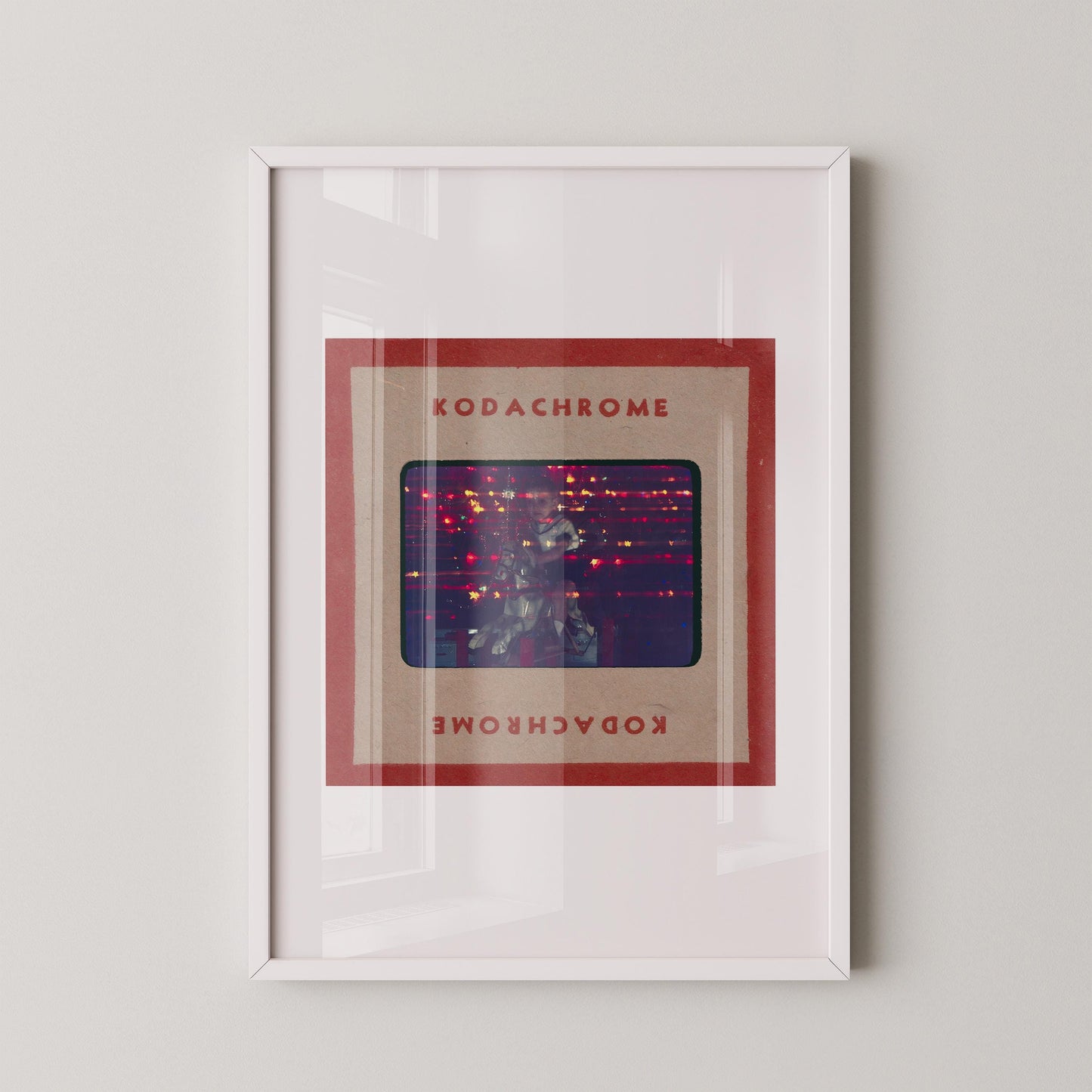 The image is a framed artwork featuring a photograph of a person in a red frame with the text "KODACHrome" and "KODACHrome" written in red below the frame.