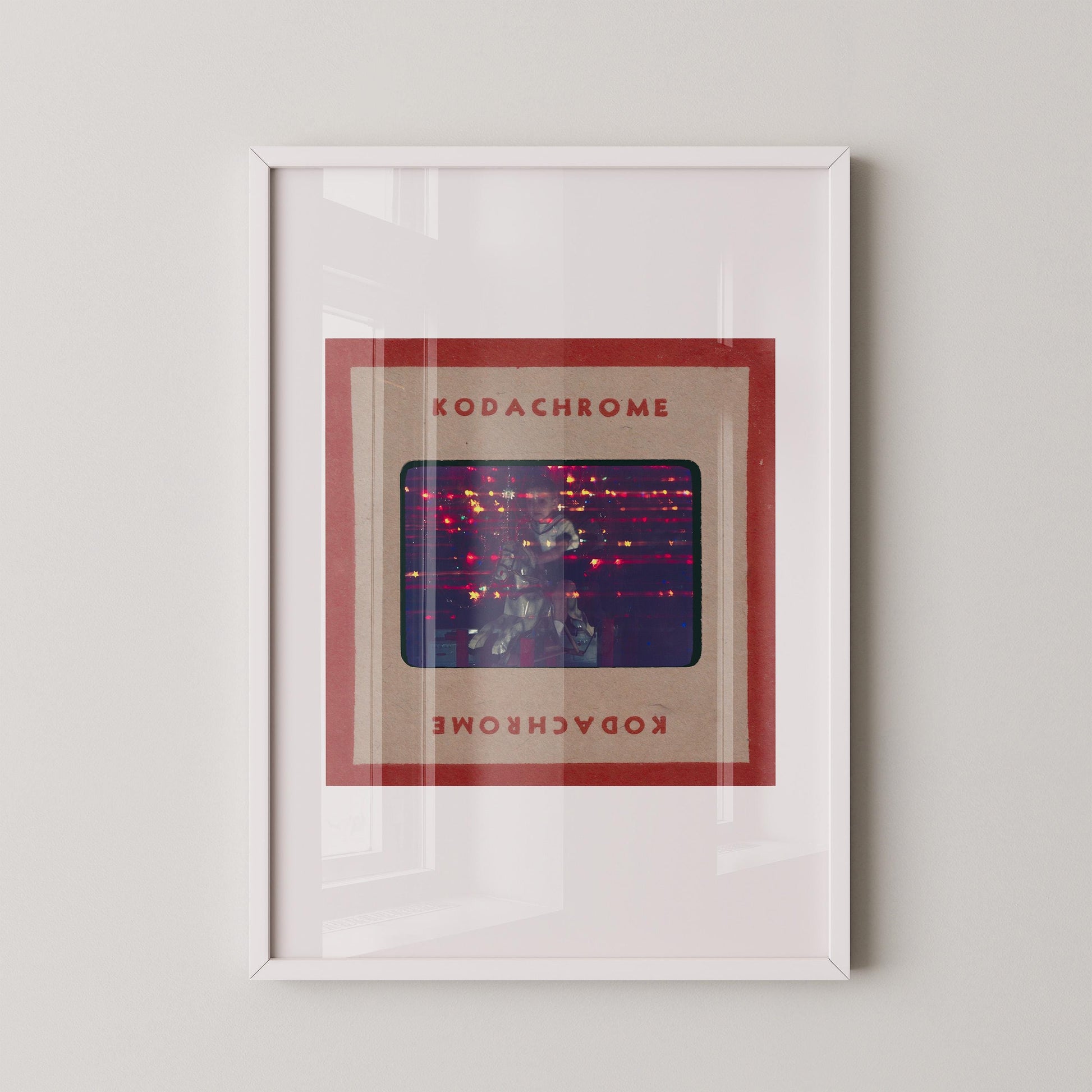 The image is a framed artwork featuring a photograph of a person in a red frame with the text "KODACHrome" and "KODACHrome" written in red below the frame.