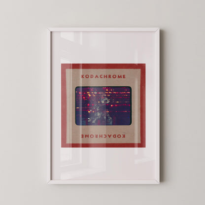 The image is a framed artwork featuring a photograph of a person in a red frame with the text "KODACHrome" and "KODACHrome" written in red below the frame.