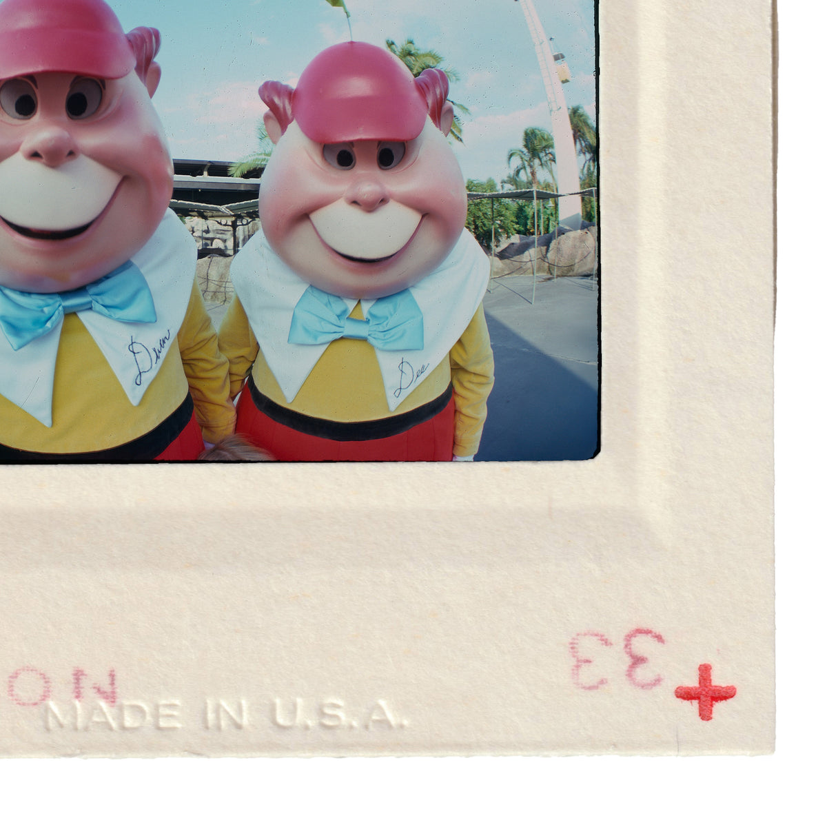 Two cartoon characters wearing yellow shirts and pink hats, smiling and posing together.