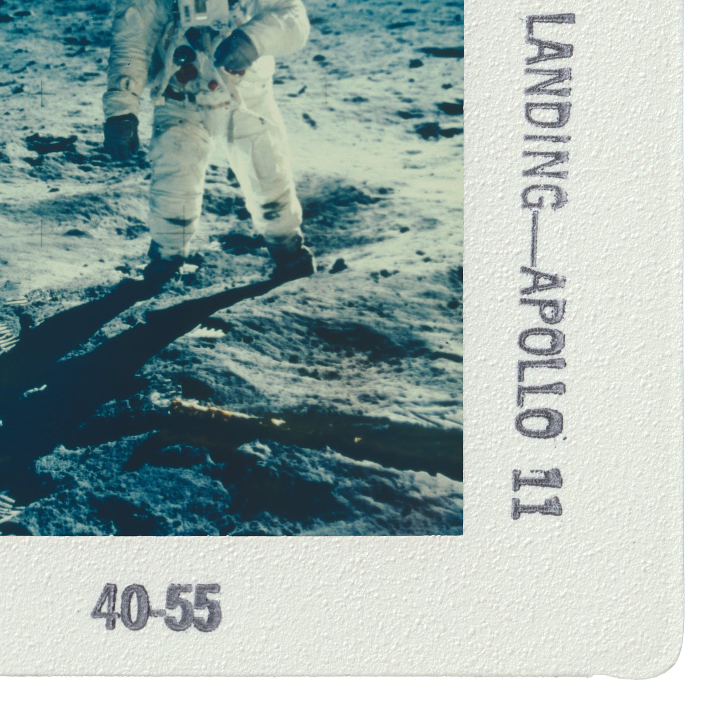 a person in a spacesuit walking on the surface of the moon, with the word "LANDING" visible in the image.