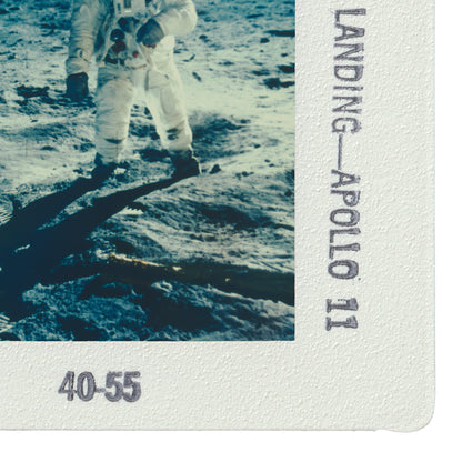 a person in a spacesuit walking on the surface of the moon, with the word "LANDING" visible in the image.