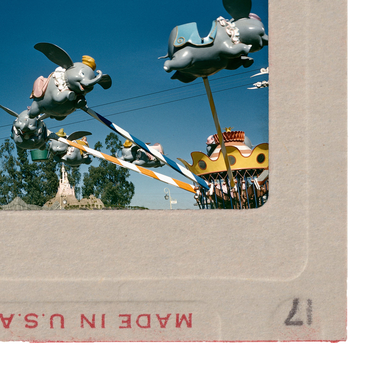 a collection of whimsical, colorful sculptures and statues, including elephants, birds, and other fantastical creatures, set against a bright blue sky.