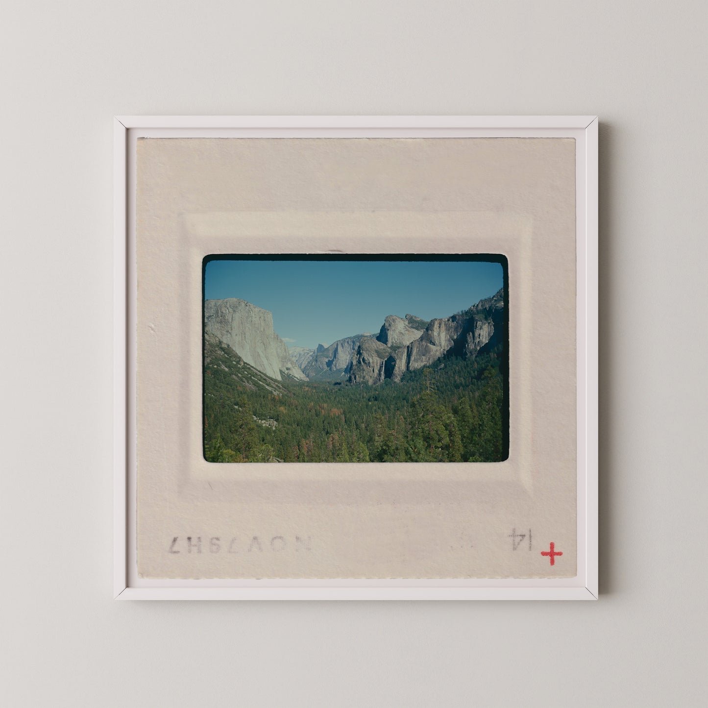 The image is a framed photograph of a scenic mountain landscape, with the mountains visible in the background.
