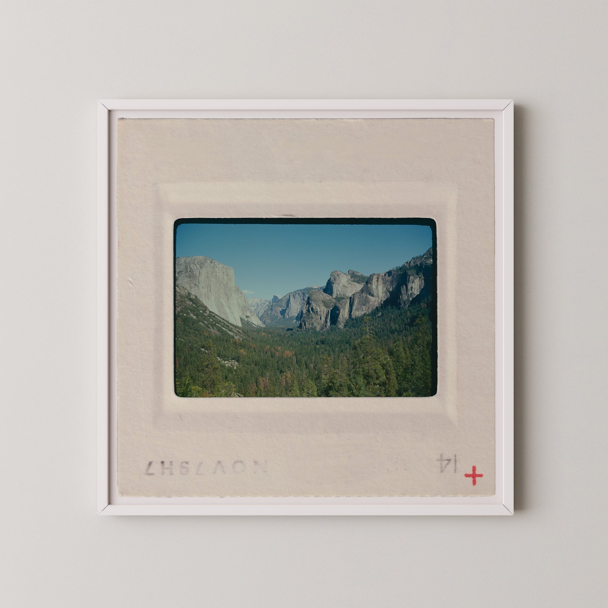 The image is a framed photograph of a scenic mountain landscape, with the mountains visible in the background.