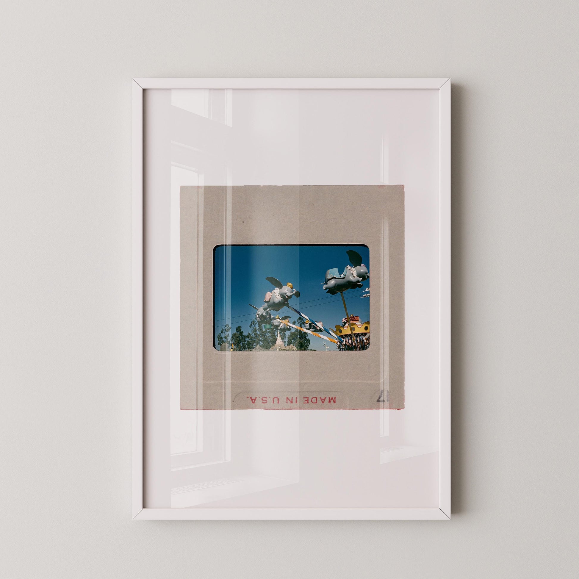 The image is a framed photograph of a person riding a skateboard, with a clear glass frame.