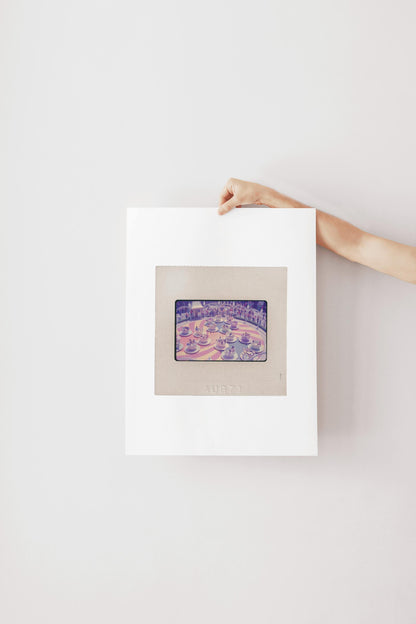 A hand is holding a framed picture of a cityscape, with the word "AUBET" visible on the frame.