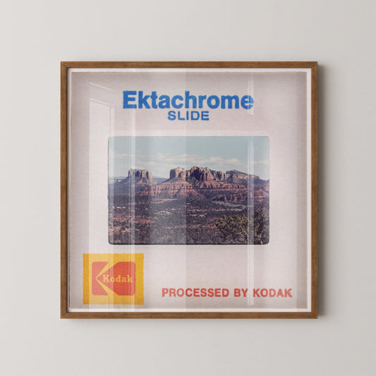 The image is a framed photograph of a desert landscape, with the text "Ektachrome Slide" and "Kodak Processed by Kodak" printed on it.