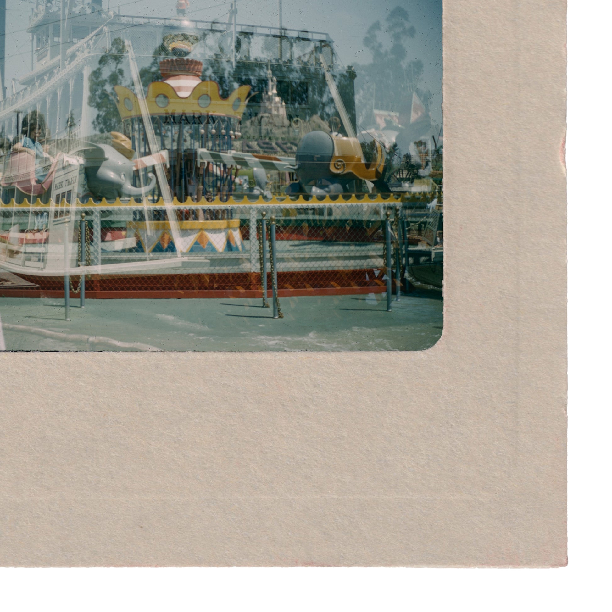 a colorful amusement park ride with various rides and attractions, including a large yellow and red structure in the background.