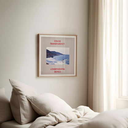 a bedroom with a bed, a framed picture of a beach, and a window with curtains.