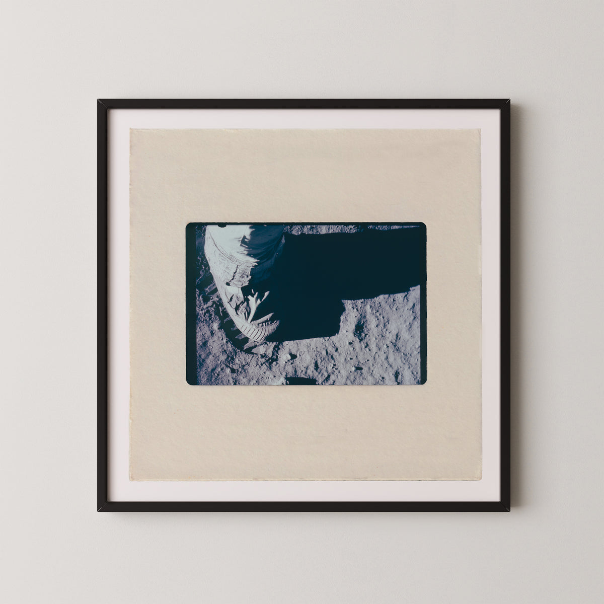 The image is a framed photograph of a person's hand, possibly a fingerprint, resting on a surface.