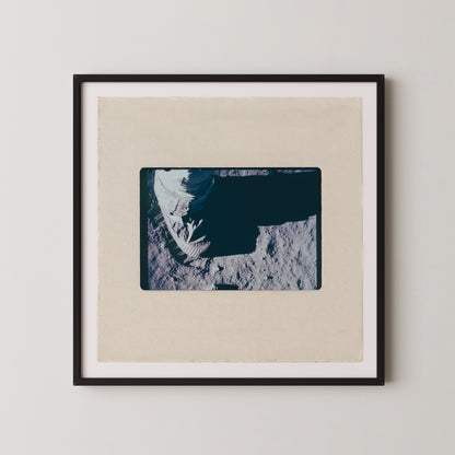 The image is a framed photograph of a person's hand, possibly a fingerprint, resting on a surface.