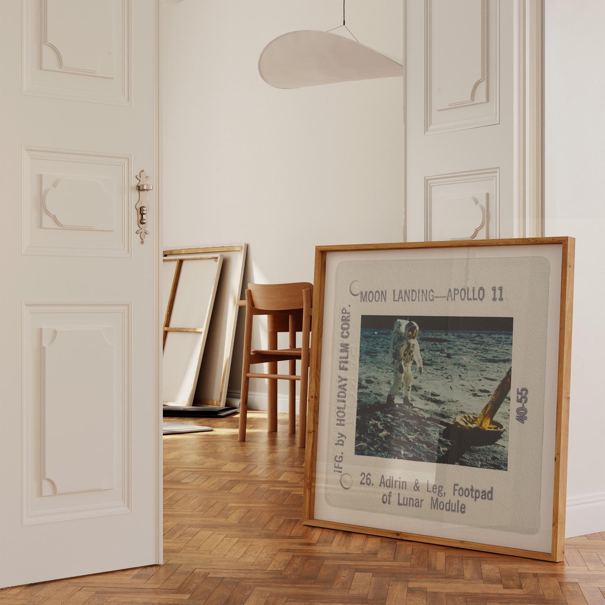 a framed photograph of an astronaut walking on the moon, with the caption "Moon Landing - Apollo 11" and the number "40-55".
