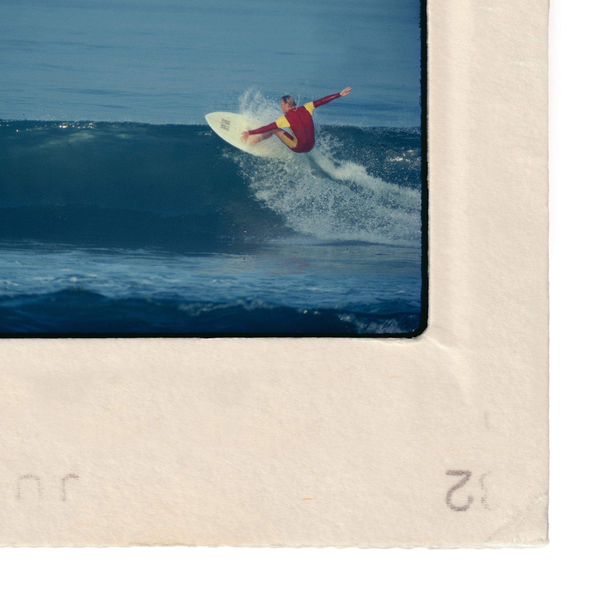 A surfer riding a wave on a white surfboard.