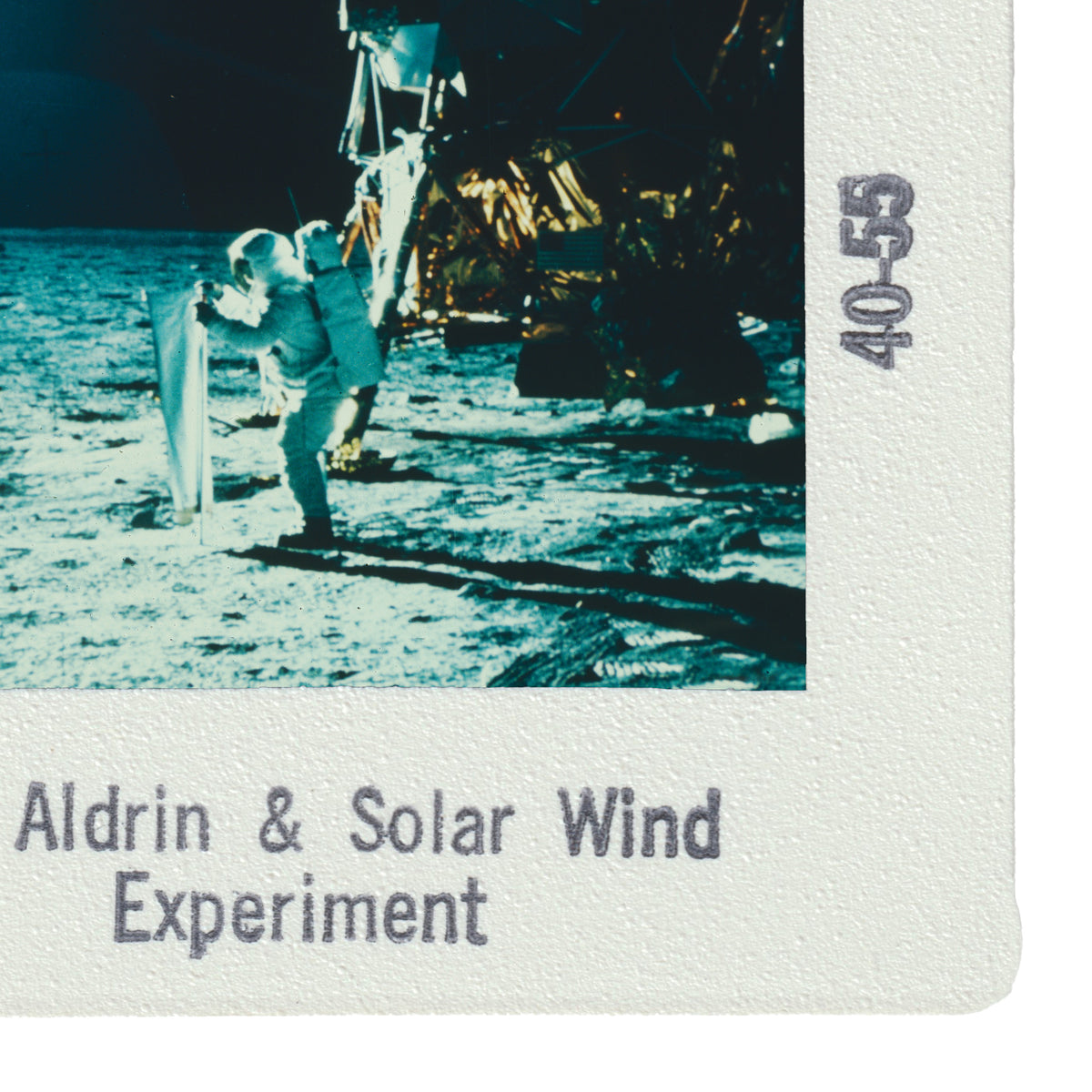 a person in a spacesuit standing on the surface of the moon, with a solar panel attached to their back. The image appears to be part of a solar wind experiment.