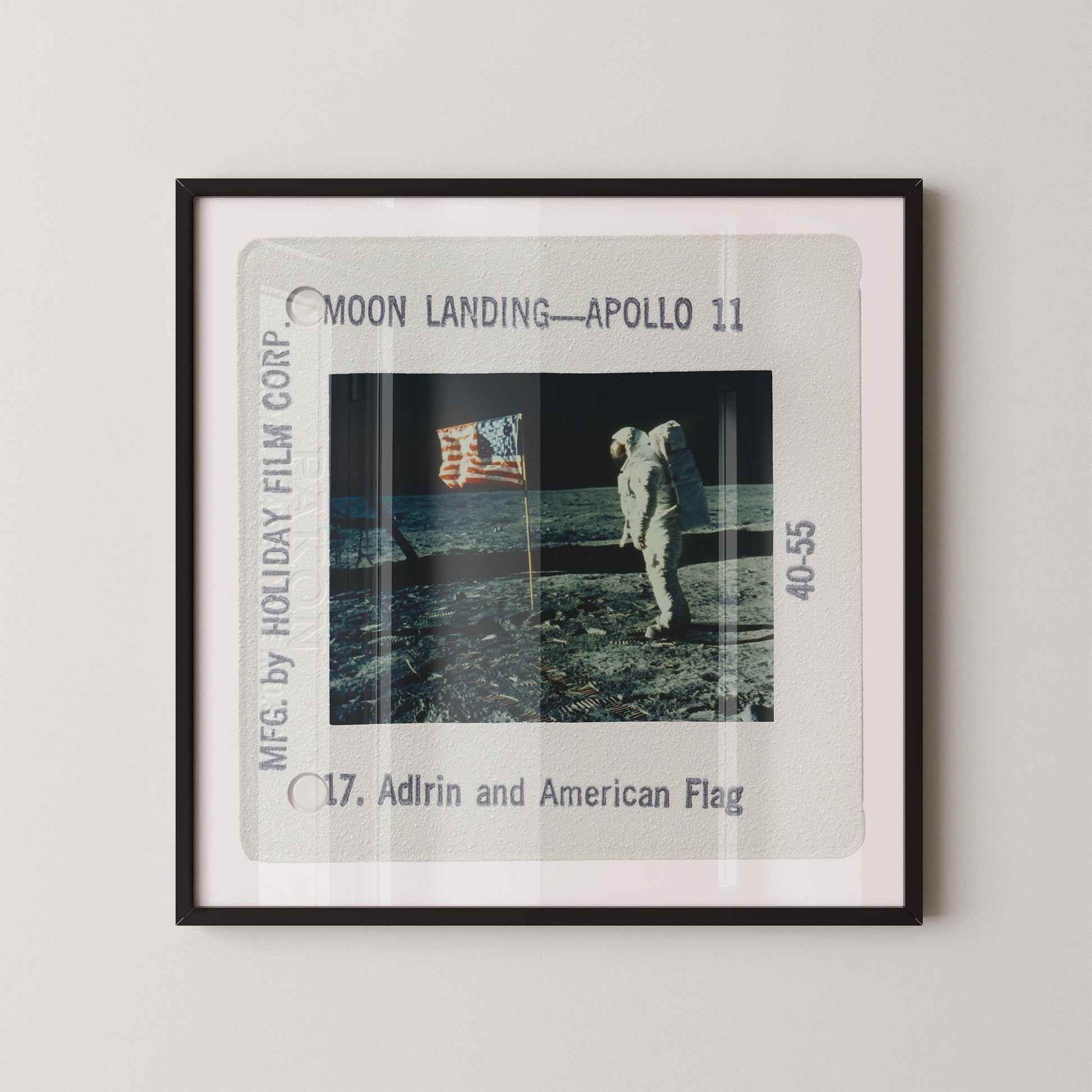 an astronaut walking on the moon's surface, holding an American flag.