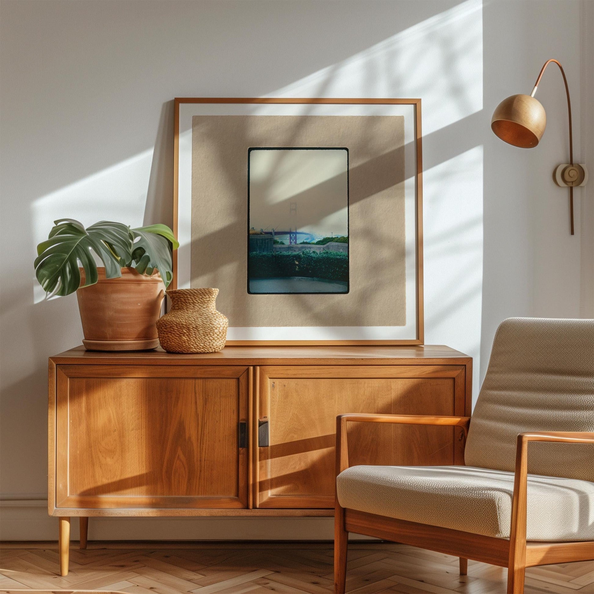 Vintage 35mm slide photograph of the Golden Gate Bridge partially obscured by dense fog, with only the tower visible above the cloud layer, viewed from a concrete overlook with green hedges in the foreground. Printed as a giclée fine art print on archival matte paper.