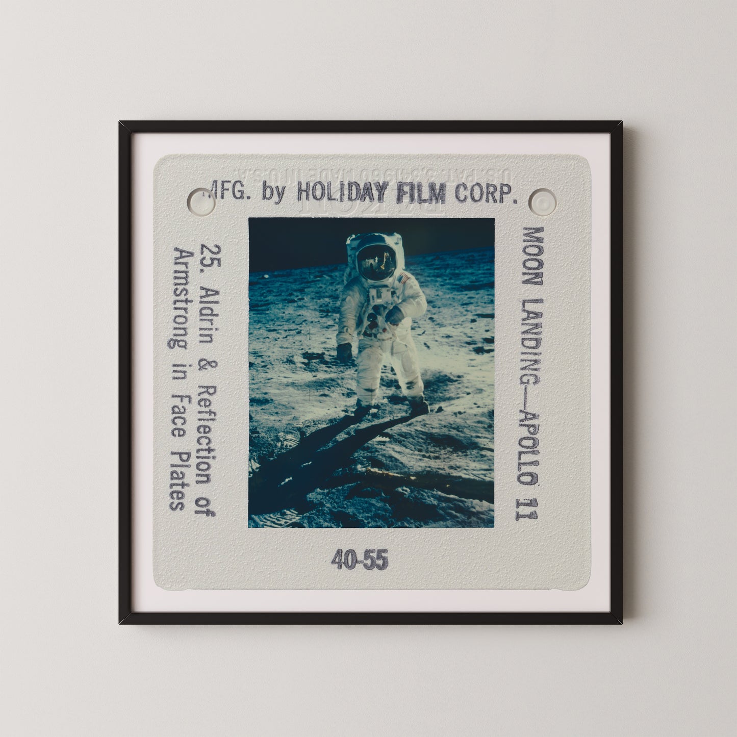 The image is a framed photograph of an astronaut walking on the surface of the moon, with the words "Moon Landing - Apollo 11" visible.