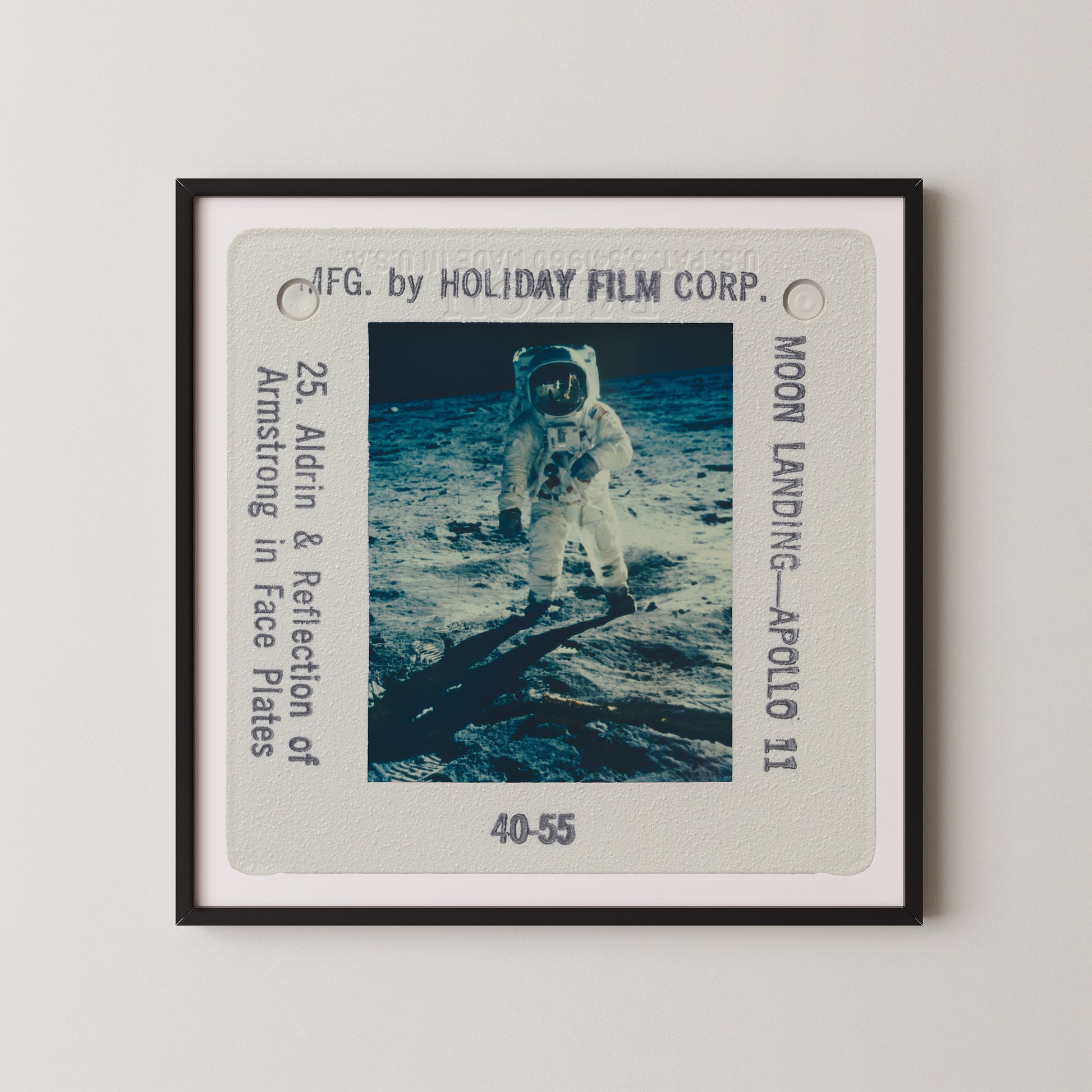 The image is a framed photograph of an astronaut walking on the surface of the moon, with the words "Moon Landing - Apollo 11" visible.