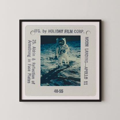 The image is a framed photograph of an astronaut walking on the surface of the moon, with the words "Moon Landing - Apollo 11" visible.