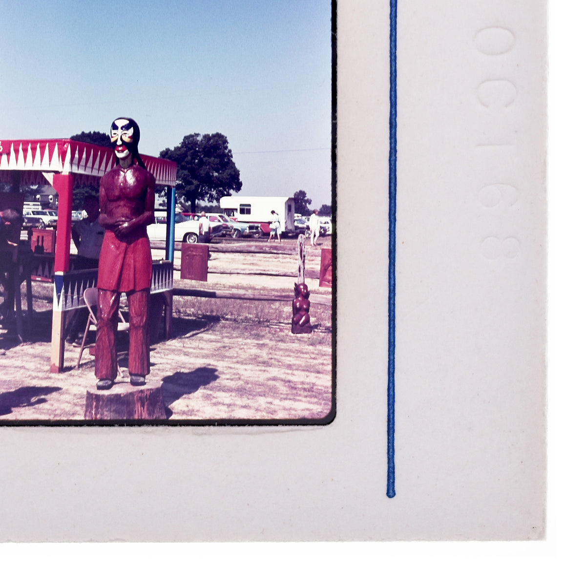 a man in a red outfit standing in front of a red and white tent, with a blue line running along the edge of the frame.