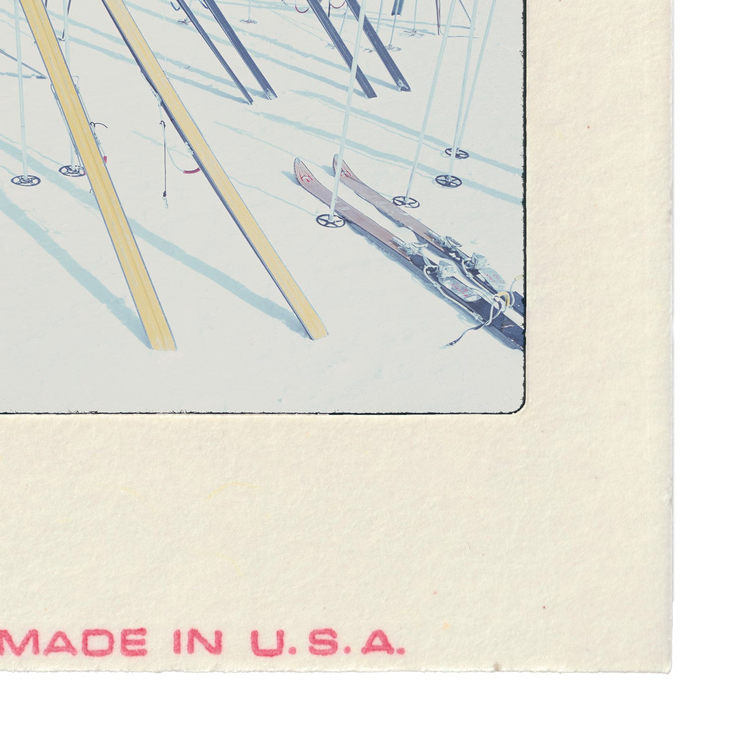 A collection of skis and ski bindings arranged in a row, with the text "MADE IN U.S.A." printed on the side of the frame.