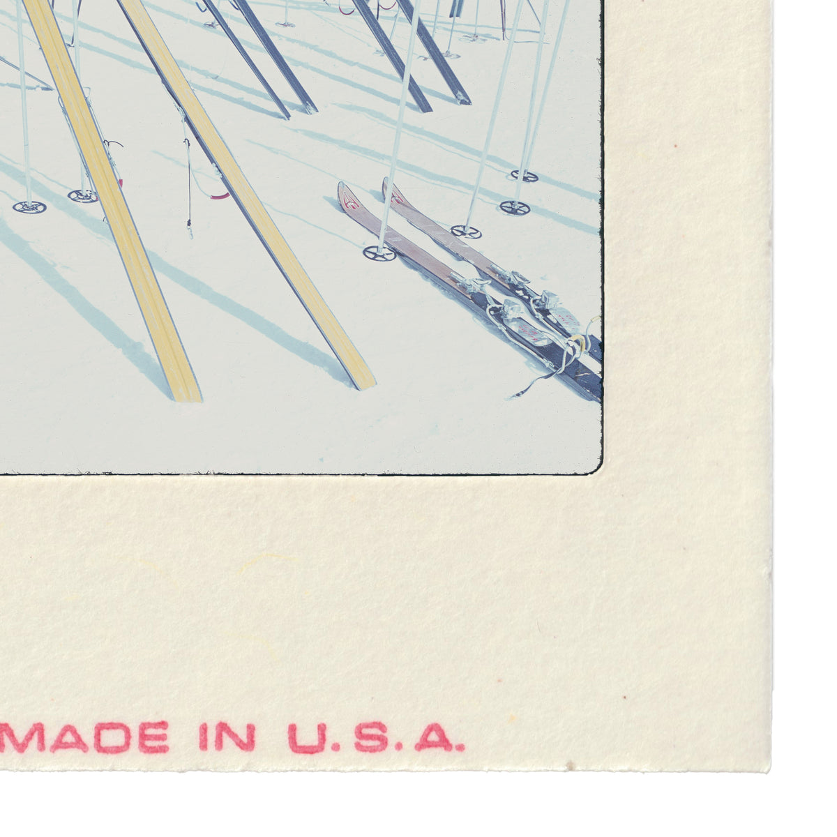 A collection of skis and ski bindings arranged in a row, with the text "MADE IN U.S.A." printed on the side of the frame.