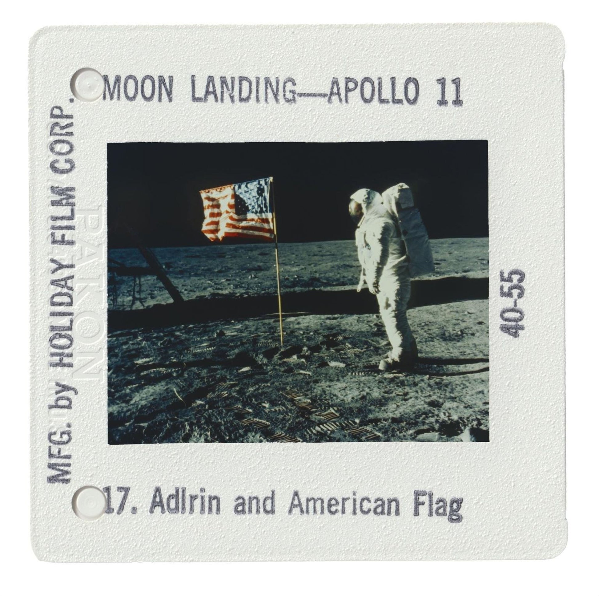 an astronaut standing on the surface of the moon, with an American flag nearby.